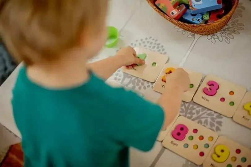 Children working with numbers and materials at preschool
